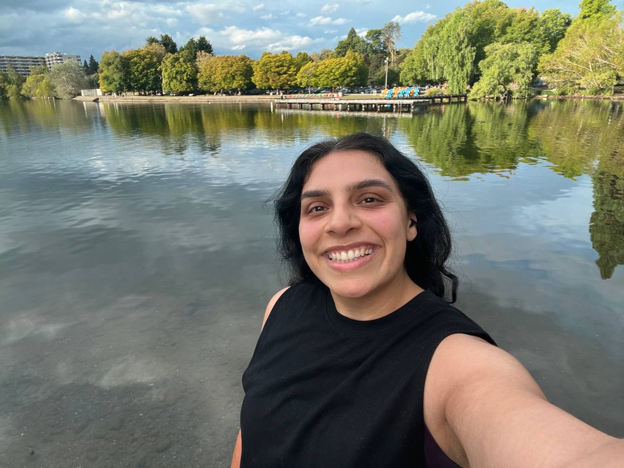 Jess smiling beside a lake