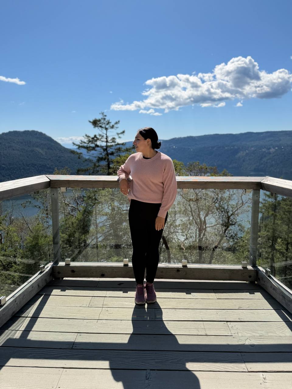 Jess standing at a sunny mountain overlook